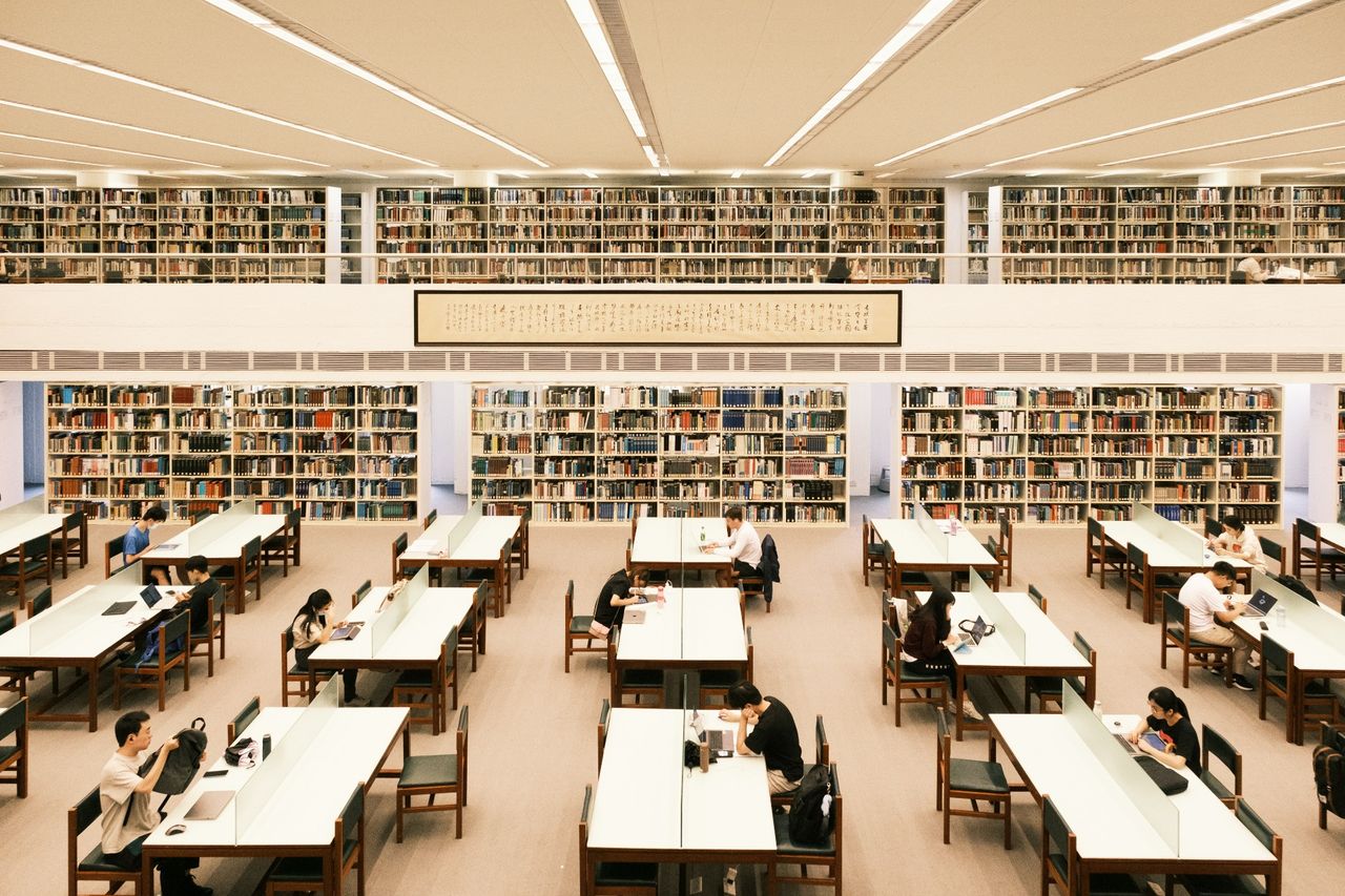 Students working in a bright, modern library.