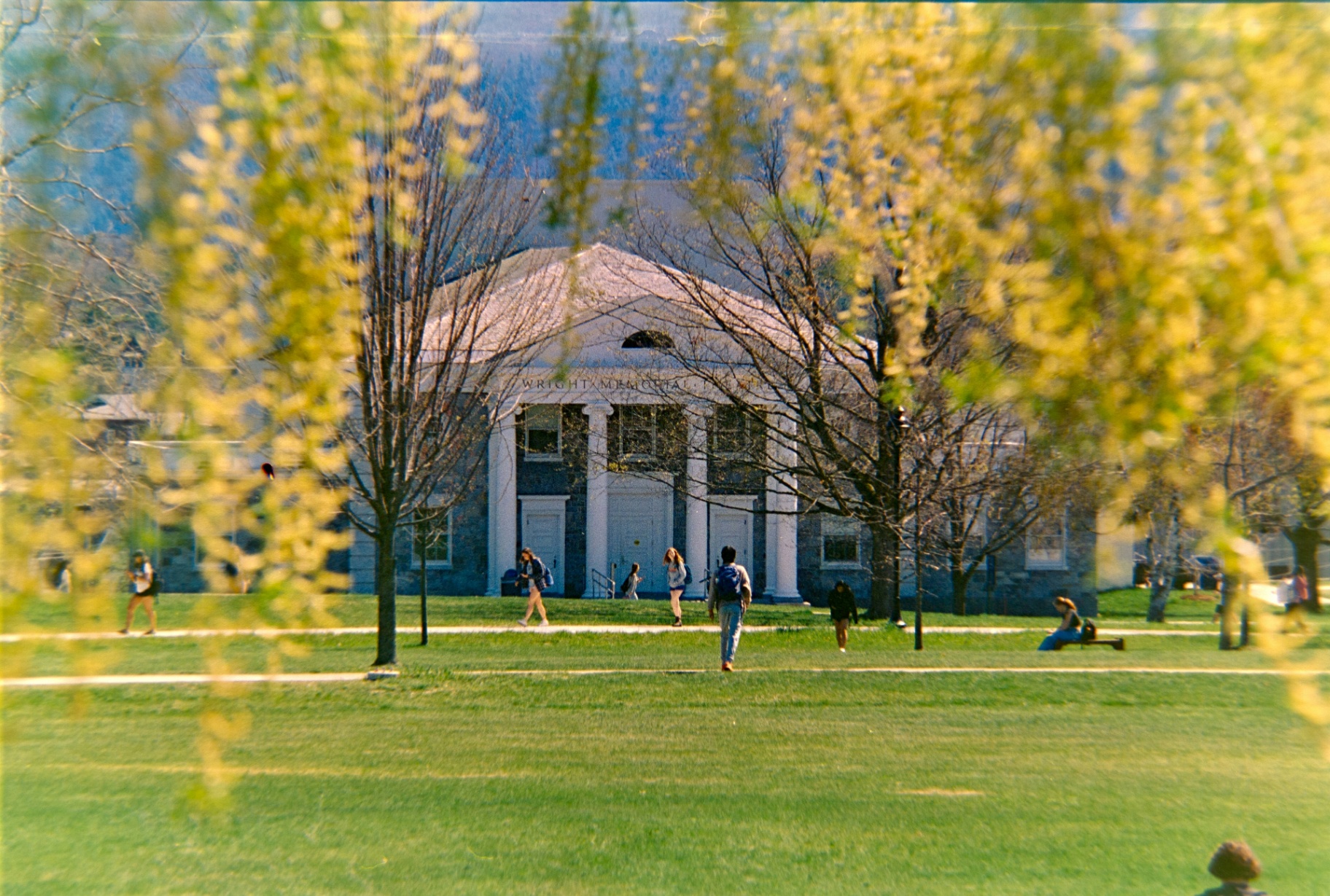 Students walking across a university campus.